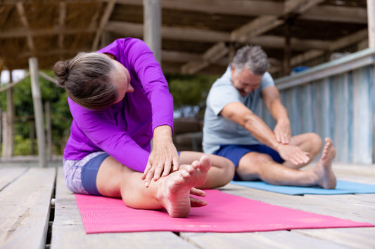 Older couple engaging in holistic stretches together