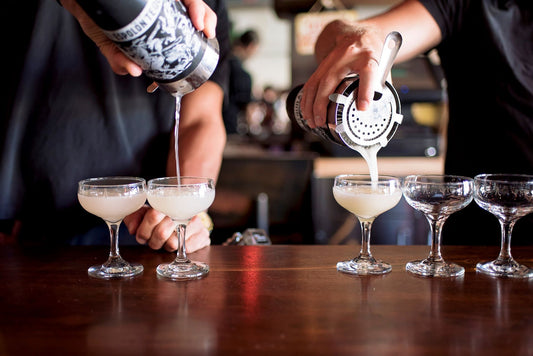 Bartenders pouring alcoholic drinks