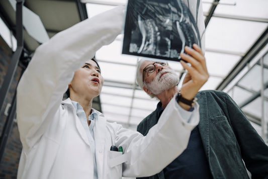 Female doctor going over xray with senior patient