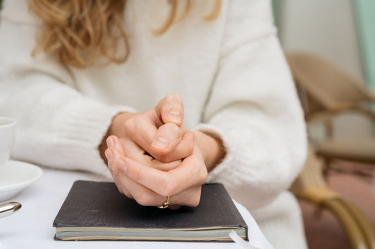 Anxious woman clasping hands